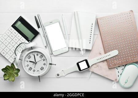 Composition with wi-fi router, phone, clock and stationery on white wooden background Stock Photo