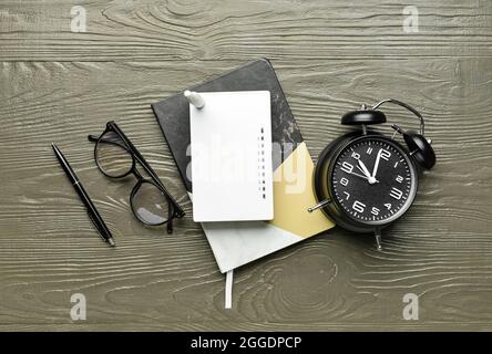 Composition with wi-fi router, clock, glasses and stationery on wooden background Stock Photo