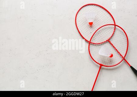 Badminton rackets and shuttlecocks on light background Stock Photo