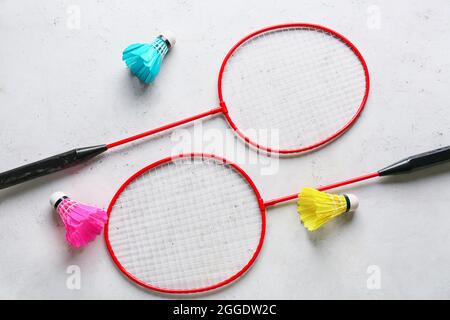 Badminton rackets and shuttlecocks on light background Stock Photo