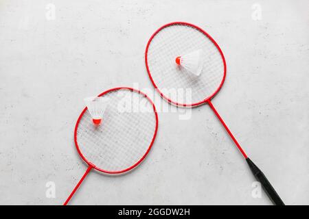 Badminton rackets and shuttlecocks on light background Stock Photo