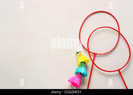 Badminton rackets and shuttlecocks on light background Stock Photo