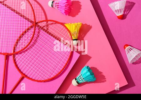 Badminton rackets and shuttlecocks on color background Stock Photo
