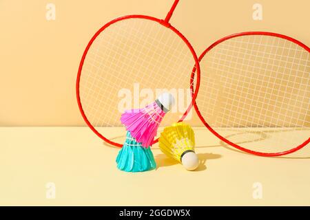Badminton rackets and shuttlecocks on color background Stock Photo