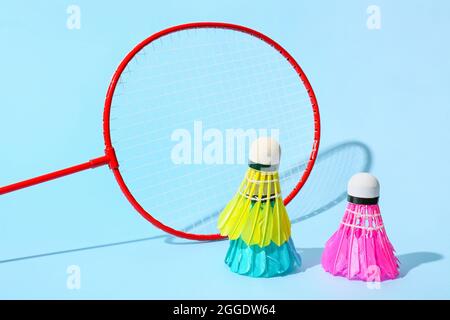 Badminton racket and shuttlecocks on color background Stock Photo
