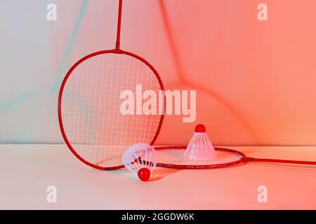 Badminton rackets and shuttlecocks on color background Stock Photo