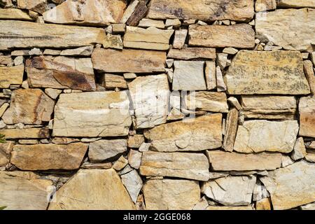 Stone wall background texture. Decorative dry masonry Stock Photo