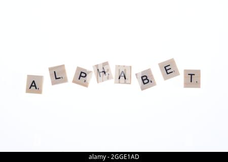 Word alphabet arranged from wooden blocks on white background. Stock Photo