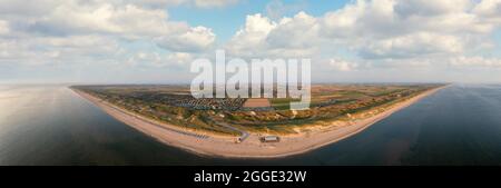 Large panoramic drone shot of the coast in front of Julianadorp aan Zee with a view of the beach, the dune, a beach bar and the Roompot holiday homes Stock Photo