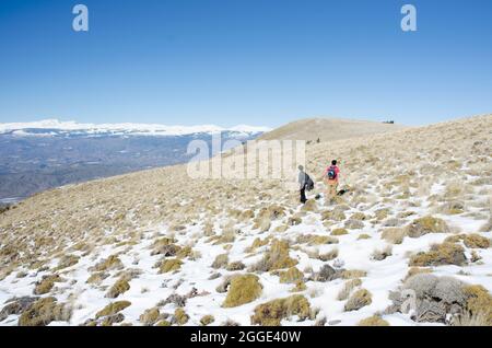two men in the snowy mountains Stock Photo