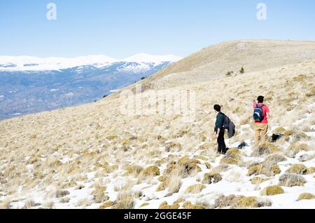 two men in the snowy mountains Stock Photo