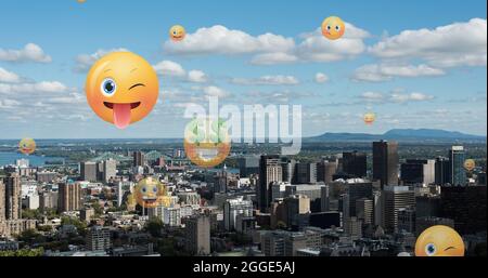 Image of emoji icons flying up over cityscape Stock Photo