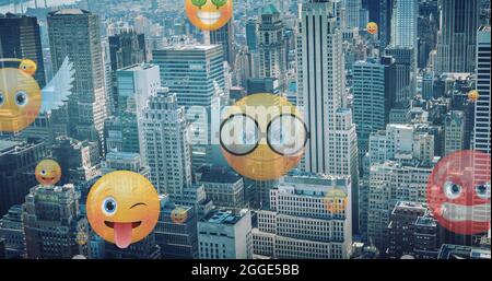 Image of emoji icons flying up over cityscape Stock Photo