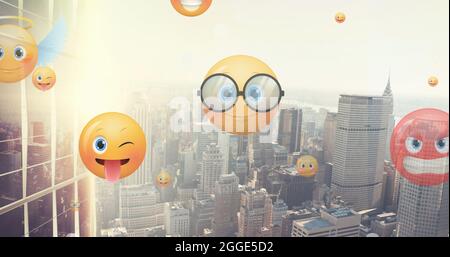 Image of emoji icons flying up over cityscape Stock Photo