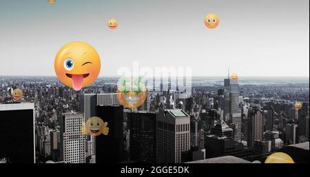 Image of emoji icons flying up over cityscape Stock Photo