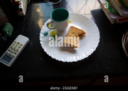 Morning breakfast. Coffee or tea is over. And the sandwich is half-eaten. Stock Photo