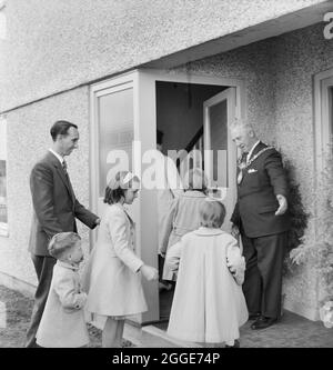 The Mayor, Councillor E. Collins, welcomes a family of six into their new home which is the first four-bedroom house to be handed over to tenants on the Leyfields housing estate. This house was one of 563 Easiform houses being constructed as part of Tamworth's scheme to house some of Birmingham's overspill population. Stock Photo
