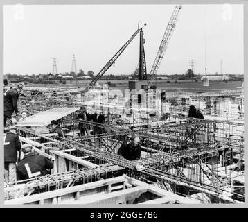 A view of the new foundry under construction at the Ford Motor Company Works, showing a team of men working on a typical section of steel reinforcement being fixed for the columns and beams of the first floor. This image was catalogued as part of the Breaking New Ground Project in partnership with the John Laing Charitable Trust in 2019-20. Stock Photo