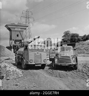 A Shell-BP fuel tanker and a Laing truck at a concrete batching plant on the construction site of the London to Yorkshire Motorway (the M1). This image was catalogued as part of the Breaking New Ground Project in partnership with the John Laing Charitable Trust in 2019-20. Stock Photo