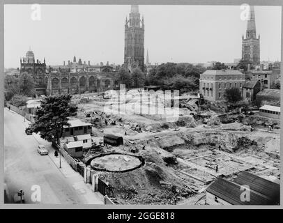 A view looking south across the construction site of Coventry Cathedral, showing the ruined Cathedral Church of St Michael in the background. The photograph shows the construction of the new Coventry Cathedral, designed by Basil Spence in 1951 and constructed between the mid-1950s and 1962. It replaced the ruined Cathedral Church of St Michael which had been badly damaged by bombing in 1941. The caption below the photograph in the album reads &quot;Looking south across the New Cathedral Site showing in the foreground the circular excavation for the pile cap to the Guild Chapel and the Boiler H Stock Photo