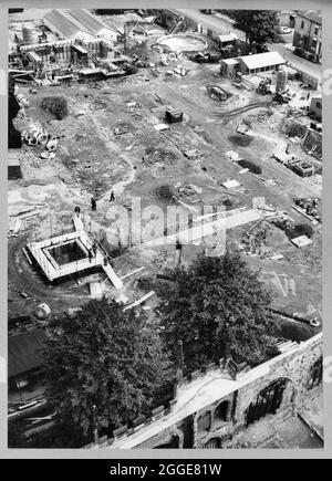 A view of the construction site of Coventry Cathedral taken from the spire of the old Coventry Cathedral, looking down on the original graveyard and the remains of the Old Priory Row which traversed the site from east to west. The photograph shows the construction of the new Coventry Cathedral, designed by Basil Spence in 1951 and constructed between the mid-1950s and 1962. It replaced the ruined Cathedral Church of St Michael which had been badly damaged by bombing in 1941. The caption below the photograph in the album reads &quot;... In the centre of the middle ground can be seen the constru Stock Photo