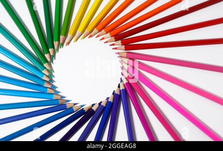 Colored pencils forming a round frame with white empty blank copy space. Color pencils concept for creative artwork, drawing and artistic school. Stock Photo