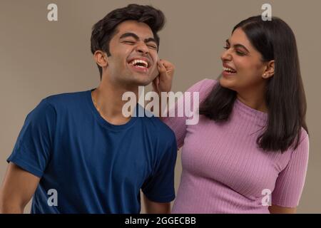 Brother teasing his sister Stock Photo - Alamy