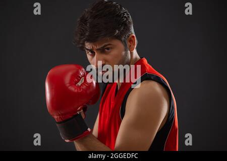 A CONFIDENT BOXER STANDING IN FRONT OF CAMERA READY TO FIGHT Stock Photo