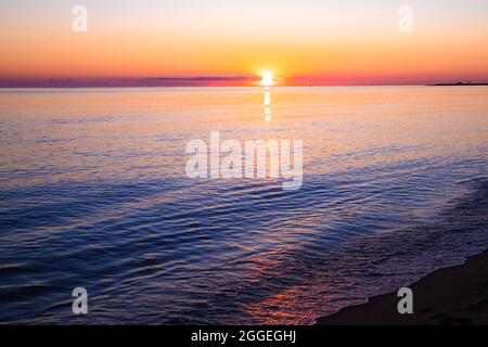 View from beach at sunset with ocean, colorful sky and sea Stock Photo