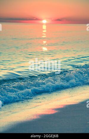 View from beach at sunset with ocean, colorful sky and sea Stock Photo