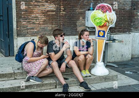 ROME, ITALY. 31 August, 2021. People sitting next to an ice cream sign in Rome. The Italian health ministry has announced that as of 31 August fully vaccinated travellers from the UK will no longer be required to quarantine for  5 days  and show a negative covid-19 test Credit: amer ghazzal/Alamy Live News Stock Photo