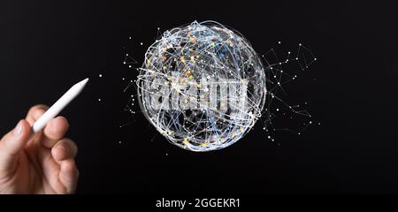 Hand points at a small sphere of network connections. Stock Photo