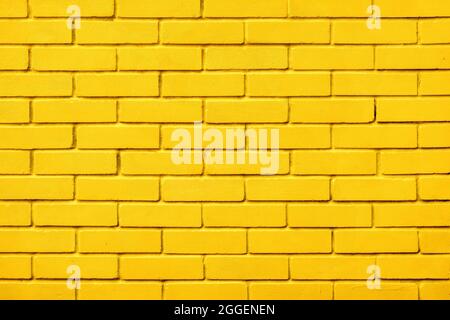 Painted bricks design yellow color wall background blocks. Natural design texture background yellow brick wall color paint block pattern. Block Stock Photo