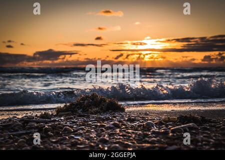 Beautiful sunset at a cloudy sky over the beach. Taken on danish island Romo Stock Photo