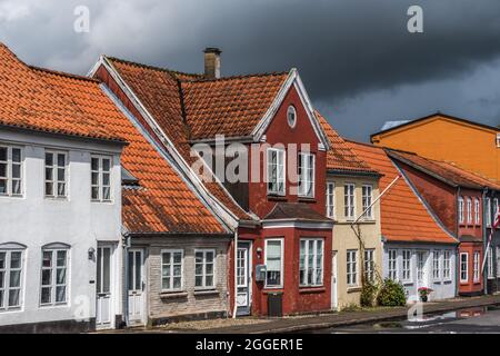 Beautiful old houses in a small street at a very rainy day, taken in Tonder, Denmark. Stock Photo