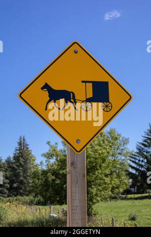 Traffic Warning Sign Slow Moving Vehicles In Huron Kinloss Ontario Canada Refer To The Amish And Mennonite Horse And Carriage Buggy Stock Photo