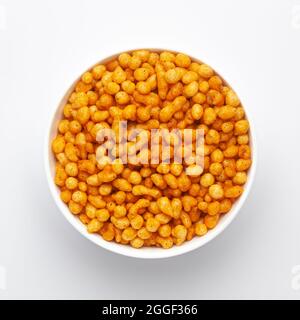 Close up of crunchy masala boondi Indian namkeen (snacks) on a ceramic white bowl. Top view Stock Photo