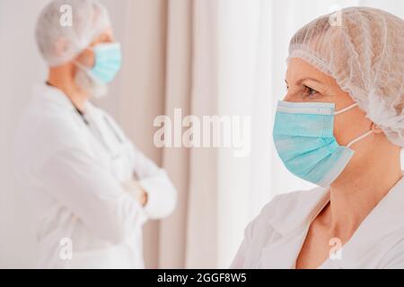 doctors with face mask think are ready to work Stock Photo