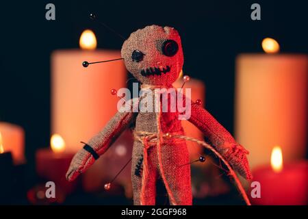 Voodoo Magic concept. Witchcraft with rag doll. Close-up of puppet nipped with needles. Stock Photo