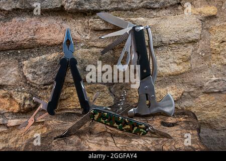camping and survival multi purpose tools on rustic wooden table ,camping and survival tools focus on army knife . Stock Photo