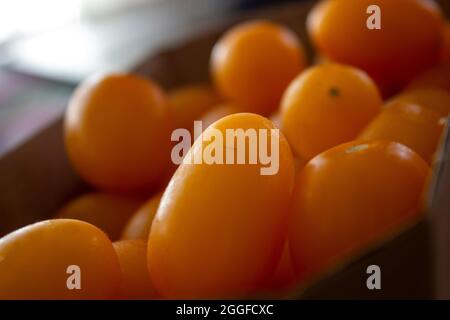 Yellow ripe cherry tomatoes in a paper box Stock Photo