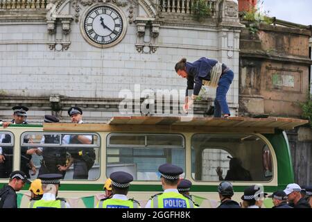 City of London, UK. 31st Aug, 2021. Protesters are arrested and led away from the scene. Extinction Rebellion (XR) have blocked London Bridge with a vintage bus, several protesters were glued and otherwise attached to the bus and ground and had to be removed by police. Credit: Imageplotter/Alamy Live News