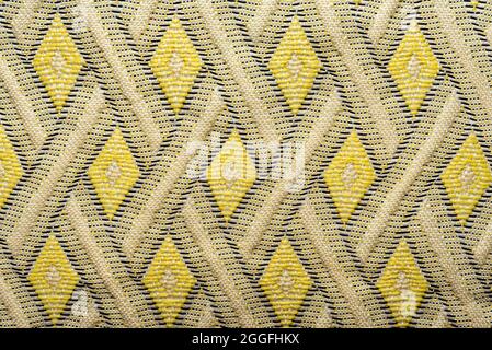 Fabric background. The texture of the material is in the form of geometric rhombuses and squares of shapes. Pattern Stock Photo