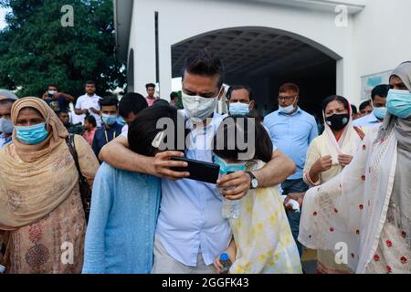 Dhaka, Bangladesh. 31st Aug, 2021. Bangladeshi American Sharif Imran and his two Japanese daughters coming out from The High Court after a hearing, in Dhaka, Bangladesh, August 31, 2021. The High Court on Tuesday asked the Bangladeshi American Sharif Imran and his Japanese wife Nakano Eriko to stay with their children at a rented house in Gulshan-1 of Dhaka for the next 15 days. On 19 August, Nakano Eriko, a citizen of Japan, filed a petition with the High Court seeking its directives to return back her two daughters Jasmine Malika, 11 and Laila Lina, 10, from their Bangladeshi father Sharif Stock Photo