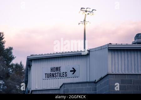 Home turnstiles sign on the side of Broadfield Stadium in Crawley, England Stock Photo