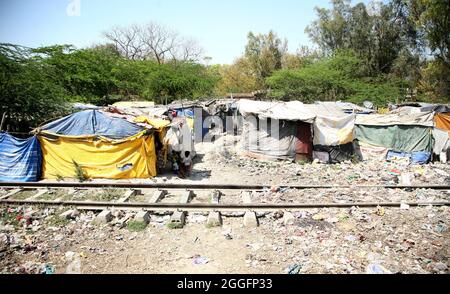 A general view of a slum area near Shakurbasti Railway station in New Delhi, India. This slum is situated on the railway's land. Stock Photo