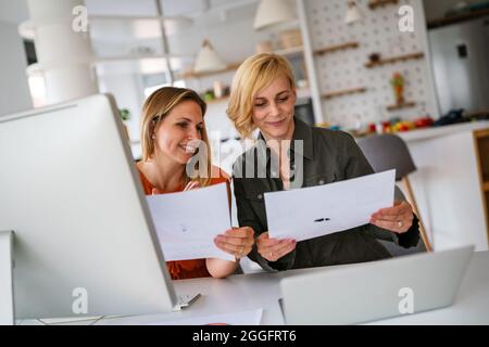 Happy business women working together at office Stock Photo