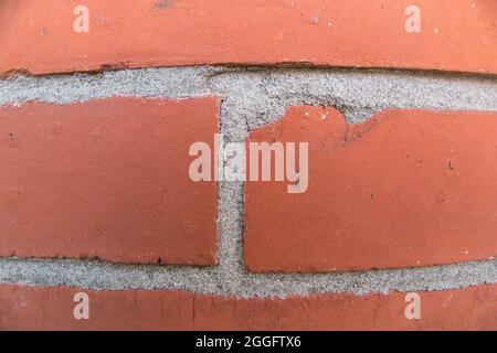 Detail of red brick wall with grey cement. Abstract background. Stock Photo