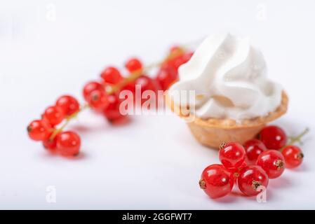 Red currant fresh berries and vanilla cream in the tart on white background Stock Photo