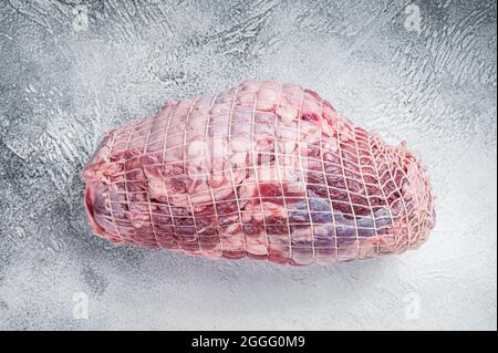 Boneless Leg of Lamb meat on butcher table. White background. Top view Stock Photo
